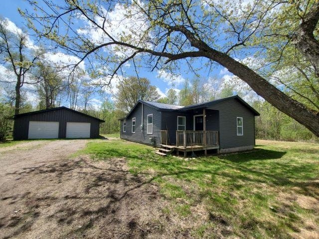 2153 Flowage Lake Rd, West Branch, MI 48661 - view of side of property featuring an outbuilding, a deck, a garage, a yard, and driveway