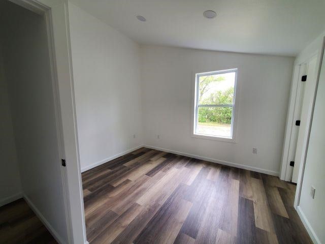 2153 Flowage Lake Rd, West Branch, MI 48661 - unfurnished room featuring wood finished floors and baseboards