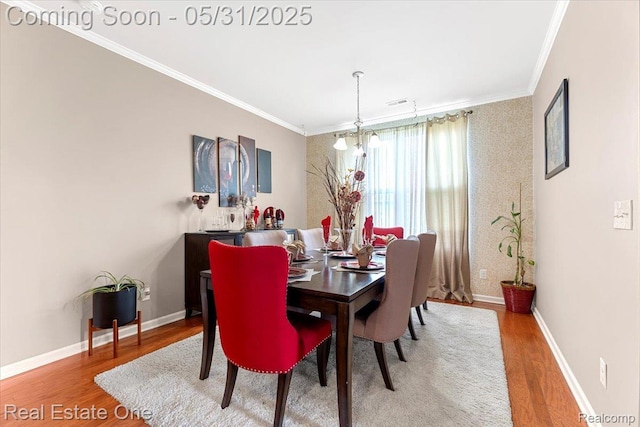 23893 Manistee Ln, Flat Rock, MI 48134 - dining space featuring wood finished floors, ornamental molding, and baseboards