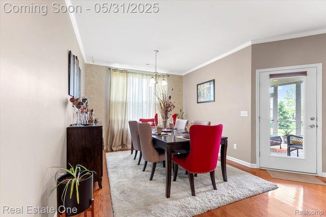 23893 Manistee Ln, Flat Rock, MI 48134 - dining area with crown molding, wood finished floors, and baseboards
