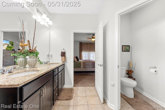 23893 Manistee Ln, Flat Rock, MI 48134 - full bath featuring double vanity, toilet, connected bathroom, tile patterned flooring, and baseboards