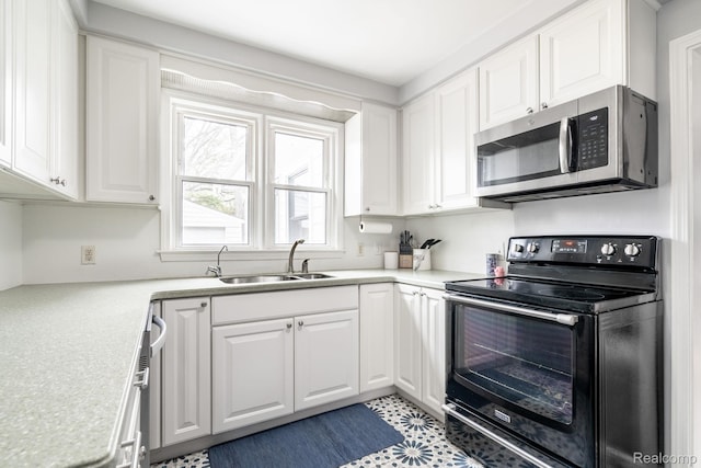 1978 Wiltshire Rd, Berkley, MI 48072 - kitchen featuring stainless steel microwave, black range with electric stovetop, a sink, and white cabinetry