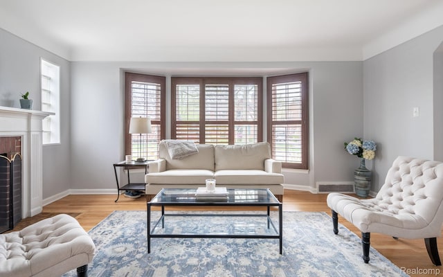 1978 Wiltshire Rd, Berkley, MI 48072 - living area featuring healthy amount of natural light, baseboards, light wood-style floors, and a brick fireplace