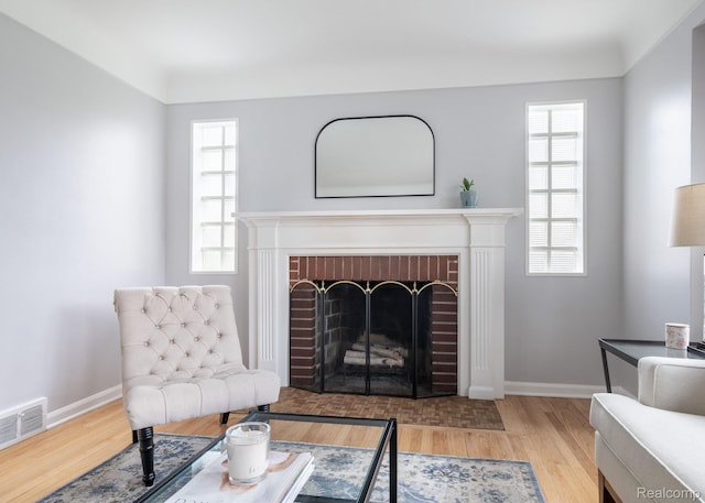 1978 Wiltshire Rd, Berkley, MI 48072 - living room featuring wood finished floors, baseboards, and a brick fireplace