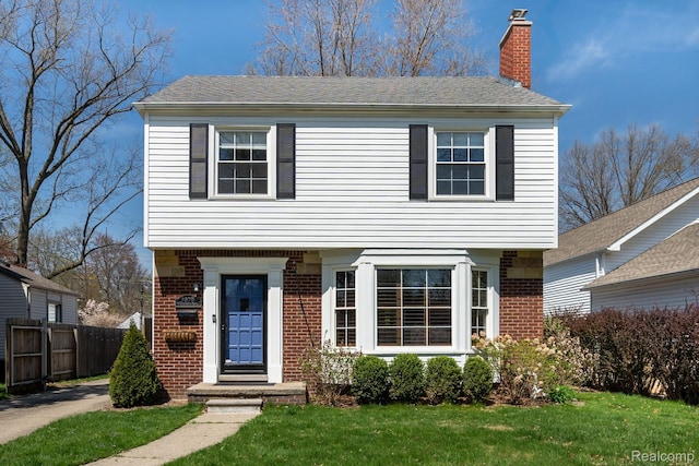 1978 Wiltshire Rd, Berkley, MI 48072 - colonial home with brick siding, a chimney, and a shingled roof