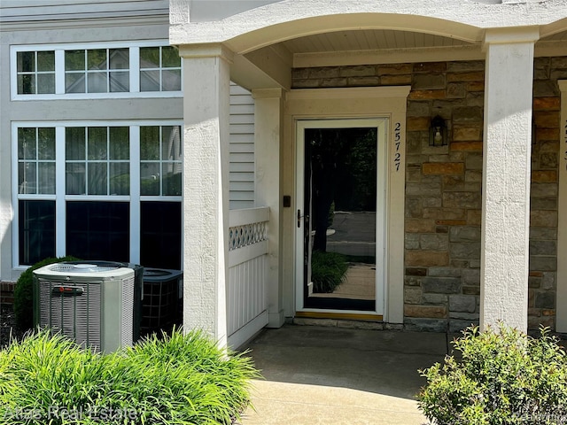 25727 Maritime Cir S, Harrison Township, MI 48045 - entrance to property featuring central air condition unit and stone siding