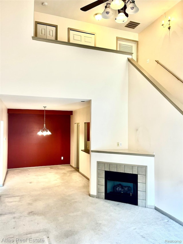 25727 Maritime Cir S, Harrison Township, MI 48045 - unfurnished living room with carpet floors, a chandelier, a tiled fireplace, and baseboards