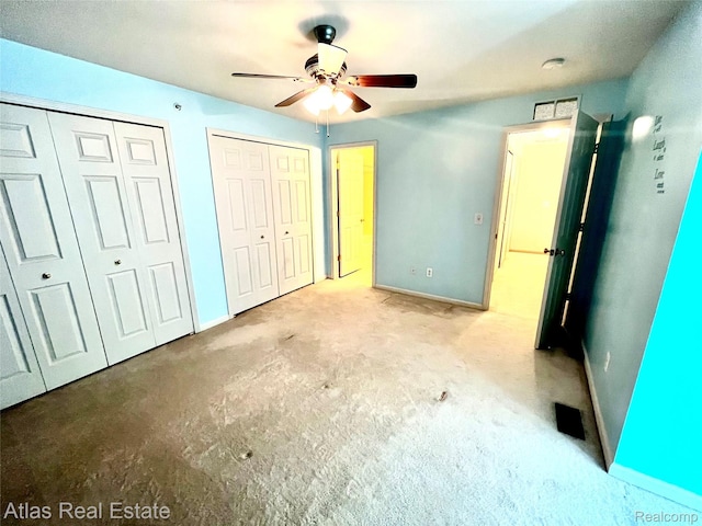 25727 Maritime Cir S, Harrison Township, MI 48045 - unfurnished bedroom featuring two closets, baseboards, and ceiling fan