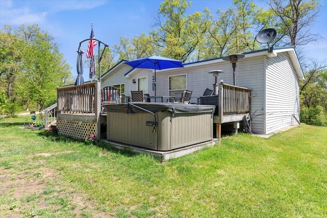 1818 E 58th St, Newaygo, MI 49337 - rear view of property with a deck, a lawn, and a hot tub