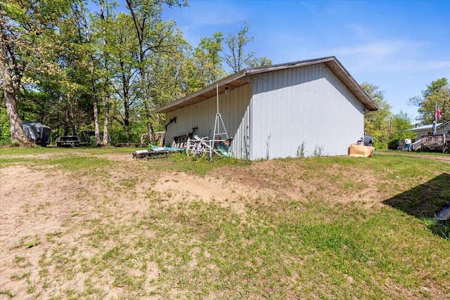 1818 E 58th St, Newaygo, MI 49337 - view of side of property featuring an outbuilding, an outdoor structure, and a yard