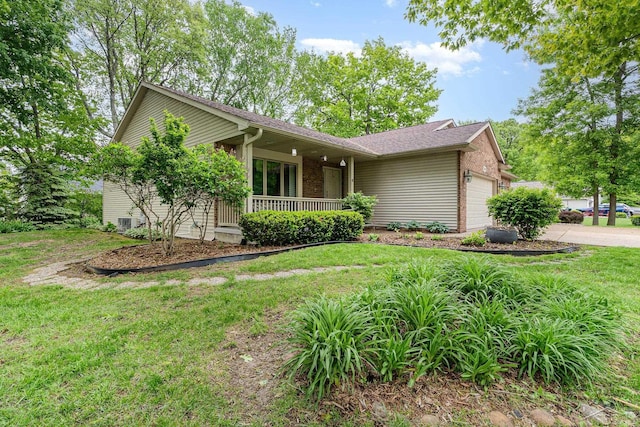 28 Barrington Cir, Saginaw, MI 48603 - single story home with an attached garage, covered porch, a front lawn, brick siding, and driveway