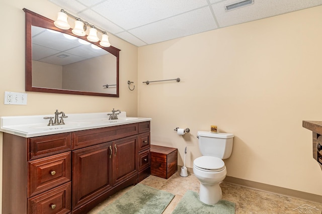 28 Barrington Cir, Saginaw, MI 48603 - bathroom with a drop ceiling, double vanity, toilet, and baseboards