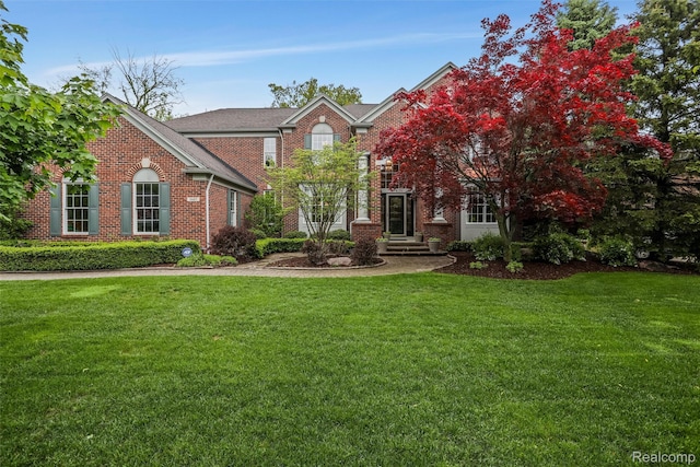 5687 Stonehaven Blvd, Rochester, MI 48306 - view of front facade with brick siding and a front yard