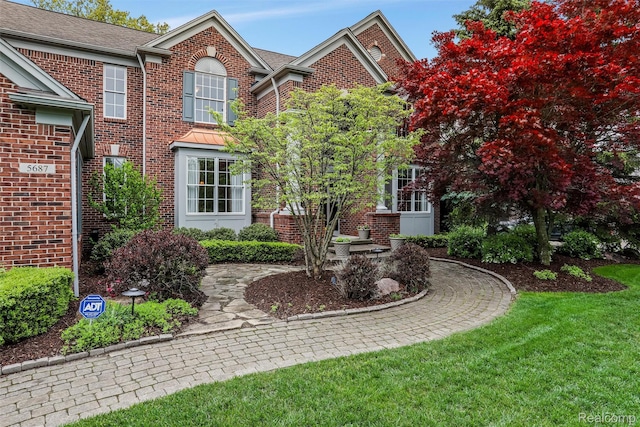5687 Stonehaven Blvd, Rochester, MI 48306 - view of front of house featuring brick siding and a front yard