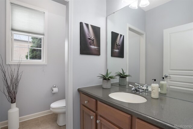 5687 Stonehaven Blvd, Rochester, MI 48306 - bathroom with vanity, toilet, baseboards, and tile patterned flooring