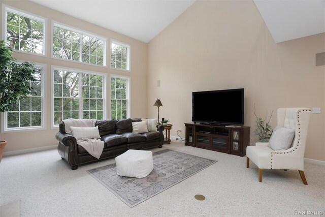 5687 Stonehaven Blvd, Rochester, MI 48306 - carpeted living area featuring high vaulted ceiling, healthy amount of natural light, and baseboards