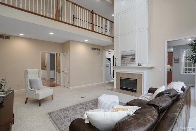 5687 Stonehaven Blvd, Rochester, MI 48306 - living area with a high ceiling, light carpet, a tile fireplace, recessed lighting, and baseboards