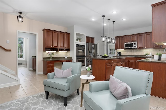 5687 Stonehaven Blvd, Rochester, MI 48306 - kitchen featuring appliances with stainless steel finishes, a center island, tasteful backsplash, light tile patterned flooring, and recessed lighting