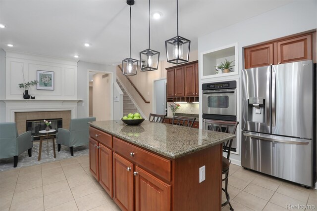 5687 Stonehaven Blvd, Rochester, MI 48306 - kitchen with stainless steel appliances, light tile patterned floors, a kitchen island, a kitchen bar, and recessed lighting