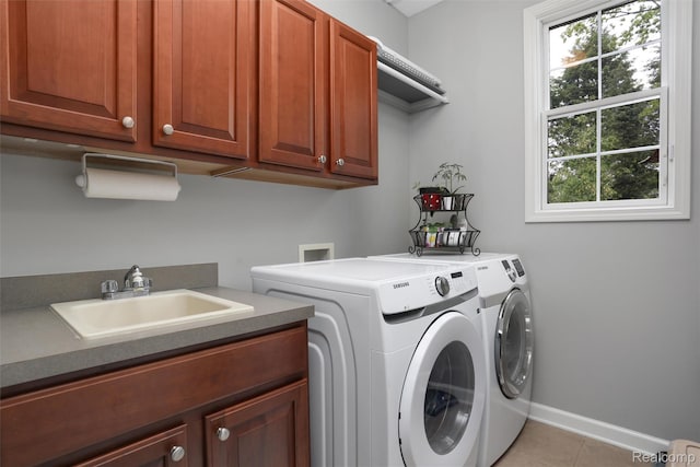 5687 Stonehaven Blvd, Rochester, MI 48306 - laundry room featuring cabinet space, washing machine and clothes dryer, baseboards, and light tile patterned floors