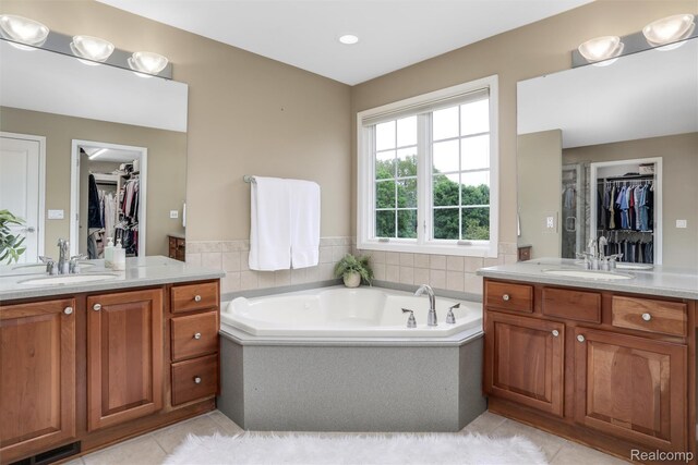 5687 Stonehaven Blvd, Rochester, MI 48306 - bathroom with tile patterned floors, two vanities, a bath, and a spacious closet