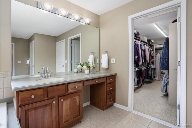 5687 Stonehaven Blvd, Rochester, MI 48306 - bathroom featuring vanity, tile patterned floors, a spacious closet, and baseboards