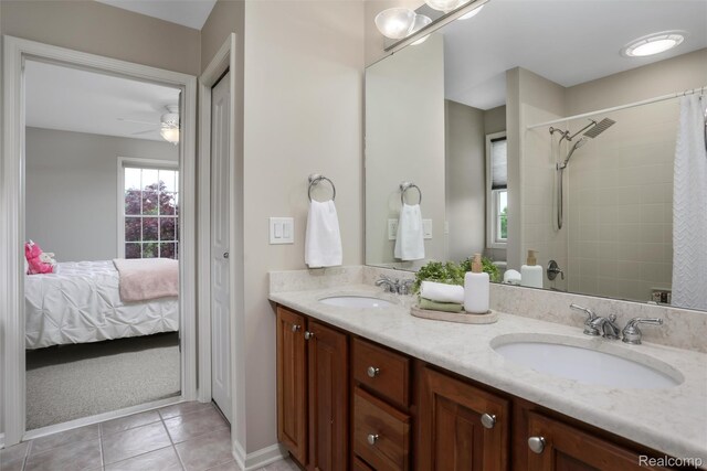 5687 Stonehaven Blvd, Rochester, MI 48306 - bathroom featuring double vanity, tile patterned flooring, a ceiling fan, ensuite bathroom, and tiled shower