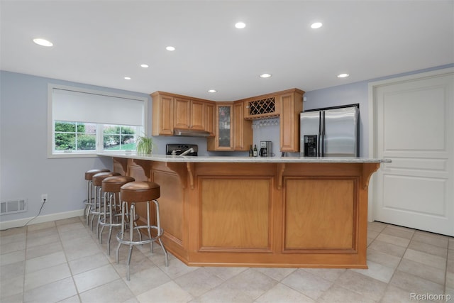 5687 Stonehaven Blvd, Rochester, MI 48306 - kitchen featuring stainless steel fridge, light countertops, a kitchen breakfast bar, glass insert cabinets, and baseboards