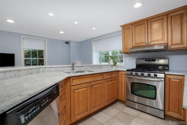 5687 Stonehaven Blvd, Rochester, MI 48306 - kitchen with stainless steel appliances, under cabinet range hood, a sink, light stone counters, and brown cabinets