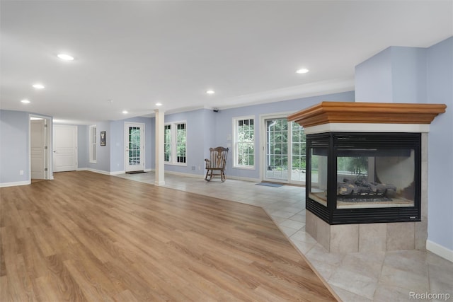 5687 Stonehaven Blvd, Rochester, MI 48306 - unfurnished living room featuring a multi sided fireplace, baseboards, recessed lighting, and light wood finished floors