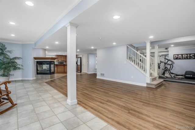 5687 Stonehaven Blvd, Rochester, MI 48306 - unfurnished living room featuring ornamental molding, recessed lighting, stairs, ornate columns, and baseboards