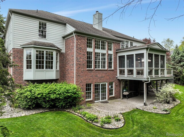 5687 Stonehaven Blvd, Rochester, MI 48306 - rear view of property featuring a patio, brick siding, a sunroom, a lawn, and a chimney