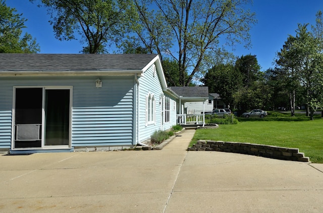 25893 Clark St, Novi, MI 48375 - view of side of home with a lawn and a patio area