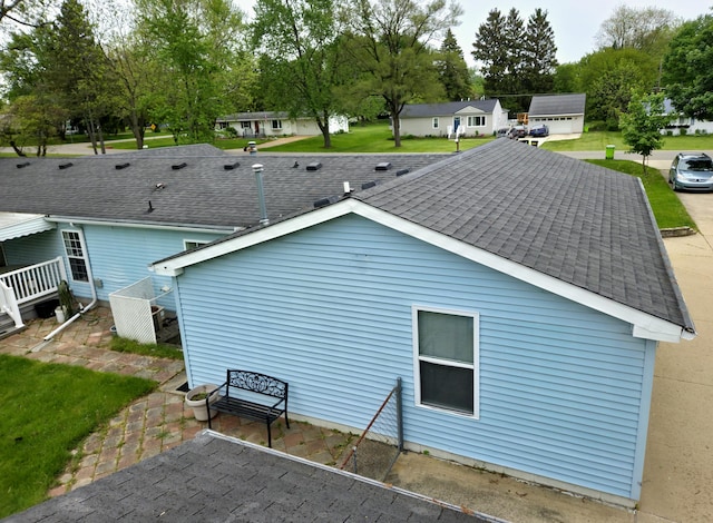 25893 Clark St, Novi, MI 48375 - view of property exterior with a shingled roof and a lawn