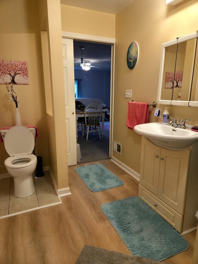 25893 Clark St, Novi, MI 48375 - half bathroom featuring toilet, wood finished floors, vanity, and baseboards