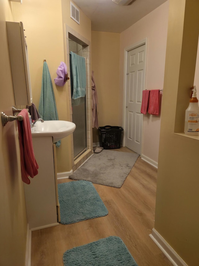 25893 Clark St, Novi, MI 48375 - full bathroom with a shower stall, wood finished floors, vanity, and baseboards