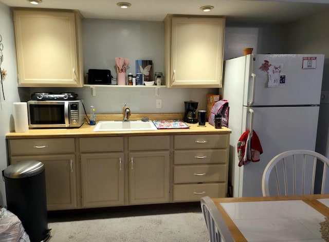 25893 Clark St, Novi, MI 48375 - kitchen featuring freestanding refrigerator, a sink, stainless steel microwave, and light countertops