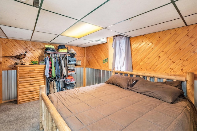 11676 Whitefish Rd, Newaygo, MI 49337 - bedroom with a paneled ceiling, carpet, wood walls, and a closet
