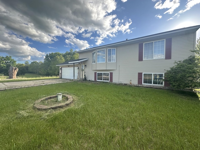 1384 Fairview Dr, Hastings, MI 49058 - rear view of property with driveway, a garage, and a lawn