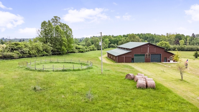 4450 50th Ave, Sears, MI 49679 - view of yard featuring a garage, a pole building, driveway, an outbuilding, and a view of trees