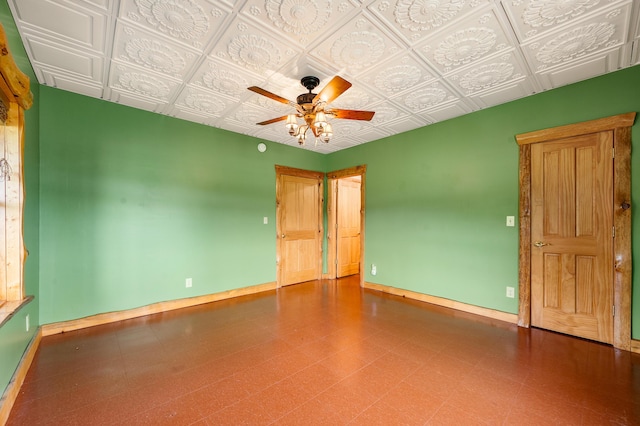 4450 50th Ave, Sears, MI 49679 - unfurnished bedroom featuring baseboards, tile patterned floors, an ornate ceiling, and a ceiling fan