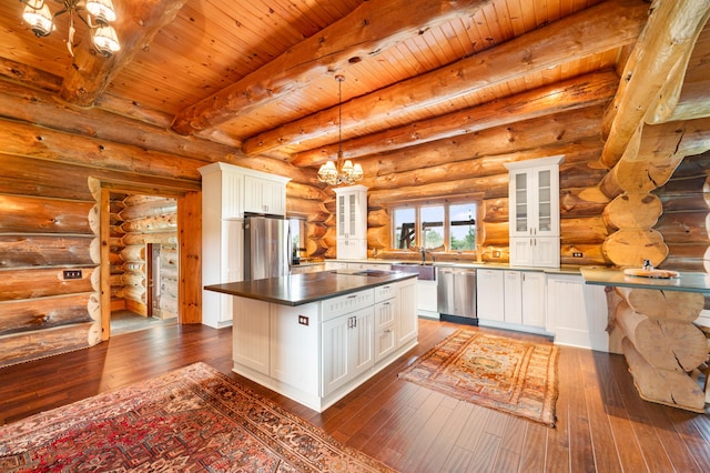 4450 50th Ave, Sears, MI 49679 - kitchen featuring stainless steel appliances, a chandelier, log walls, dark wood finished floors, and dark countertops