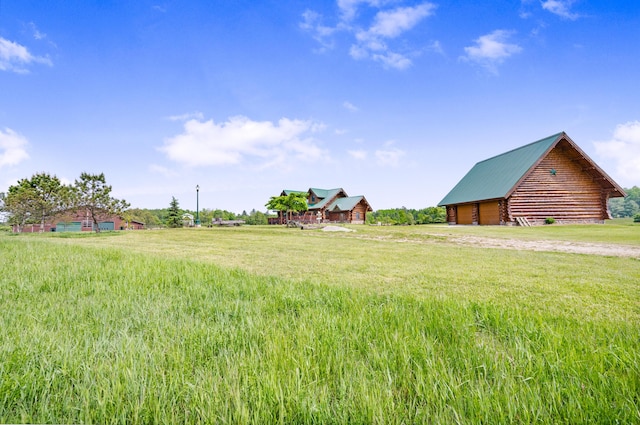 4450 50th Ave, Sears, MI 49679 - view of yard featuring a garage and driveway