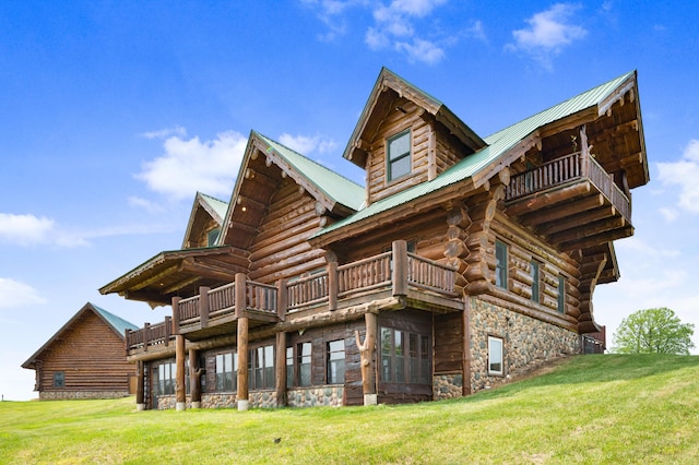 4450 50th Ave, Sears, MI 49679 - rear view of house with a lawn, stone siding, and a balcony