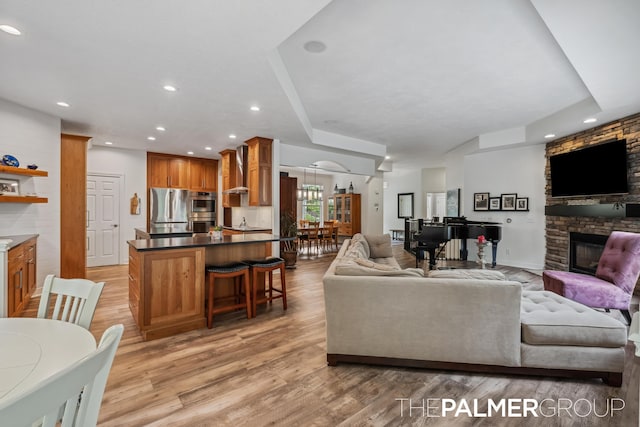 7149 Armadale Ct NE, Belmont, MI 49306 - living area with a fireplace, light wood-style flooring, and recessed lighting