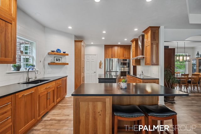 7149 Armadale Ct NE, Belmont, MI 49306 - kitchen with wall chimney range hood, a sink, dark countertops, a kitchen island, and appliances with stainless steel finishes