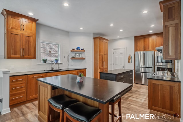 7149 Armadale Ct NE, Belmont, MI 49306 - kitchen with a sink, appliances with stainless steel finishes, a kitchen island, dark countertops, and recessed lighting