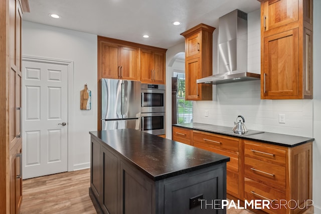 7149 Armadale Ct NE, Belmont, MI 49306 - kitchen with wall chimney range hood, appliances with stainless steel finishes, dark countertops, arched walkways, and recessed lighting