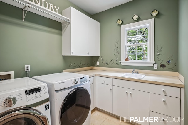 7149 Armadale Ct NE, Belmont, MI 49306 - laundry room with washer and dryer, cabinet space, and light tile patterned floors