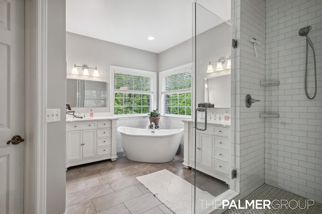 7149 Armadale Ct NE, Belmont, MI 49306 - full bathroom featuring vanity, a freestanding bath, a shower stall, tile patterned floors, and recessed lighting